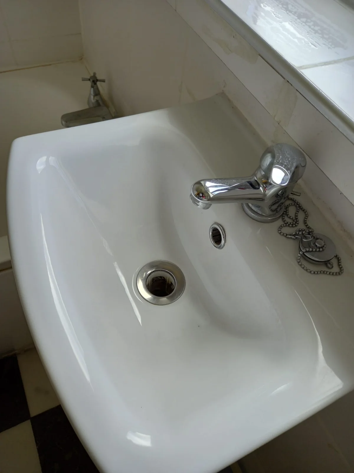 Bathroom sink, faucet and drain scrubbed and polished